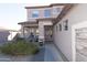 Inviting front entrance with a covered porch, security door and desert landscaping at 17441 W Rock Ledge Rd, Goodyear, AZ 85338