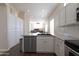 Well-equipped kitchen with stainless steel appliances, white cabinetry, and an open layout at 17441 W Rock Ledge Rd, Goodyear, AZ 85338