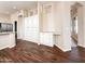 Spacious kitchenette with lots of white cabinets, drawers and counter space and wood look tile floors at 17441 W Rock Ledge Rd, Goodyear, AZ 85338