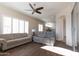 Comfortable living room with tile floors, a ceiling fan, and access to the kitchen at 17441 W Rock Ledge Rd, Goodyear, AZ 85338