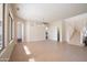 Open-concept living room featuring tile flooring, archways, and a staircase at 17441 W Rock Ledge Rd, Goodyear, AZ 85338