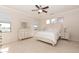 A well-lit main bedroom with neutral furnishings and carpeted floors at 17441 W Rock Ledge Rd, Goodyear, AZ 85338