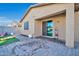 A view of the covered patio, paver patio, and lawn area from the backyard at 17634 W Via De Luna Dr, Surprise, AZ 85387