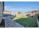 This backyard is landscaped with an artificial lawn, pavers, and a playhouse at 17634 W Via De Luna Dr, Surprise, AZ 85387