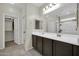 Bathroom features a double sink vanity and a large mirror, plus an open closet at 17634 W Via De Luna Dr, Surprise, AZ 85387