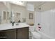 Well-lit bathroom showcasing a single sink vanity and a shower-tub combo at 17634 W Via De Luna Dr, Surprise, AZ 85387