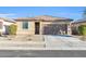 Charming single-story home featuring a two-car garage and low maintenance desert landscaping at 17634 W Via De Luna Dr, Surprise, AZ 85387