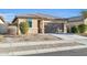 Charming single-story home featuring a two-car garage and low maintenance desert landscaping at 17634 W Via De Luna Dr, Surprise, AZ 85387