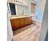 This bathroom features a dual sink vanity, a large mirror, and a soaking tub at 18391 W Stinson Dr, Surprise, AZ 85374