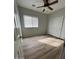 Bright bedroom featuring wood flooring, a ceiling fan, and a closet for storage at 18391 W Stinson Dr, Surprise, AZ 85374