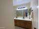 Bathroom with double sink vanity, large mirrors, and modern lighting at 18841 N Palomar Dr, Sun City West, AZ 85375