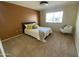 Well-lit bedroom with a queen bed, comfortable carpet, and a modern chair at 18841 N Palomar Dr, Sun City West, AZ 85375