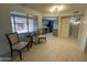 Cozy dining area with a window view, with a peek into the kitchen, and tile flooring at 18841 N Palomar Dr, Sun City West, AZ 85375