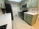 Well-lit kitchen featuring stainless steel appliances and light green cabinetry at 18841 N Palomar Dr, Sun City West, AZ 85375