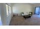 Spacious living room featuring neutral tones, plush carpeting, and modern furniture at 18841 N Palomar Dr, Sun City West, AZ 85375