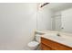 Bathroom featuring a wood vanity with a sink, toilet, large mirror, and shower at 1903 E San Tan St, Chandler, AZ 85225