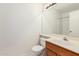 Bathroom featuring a wood vanity with a sink, toilet, large mirror, and shower at 1903 E San Tan St, Chandler, AZ 85225