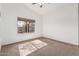 Sunlit bedroom featuring a large window and neutral carpet at 1903 E San Tan St, Chandler, AZ 85225