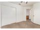 Bedroom with carpeted floors, closet with white sliding doors and a light-colored door to the hallway at 1903 E San Tan St, Chandler, AZ 85225