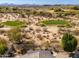 Bird's eye view of lush desert golf course community with mountain views in the background at 19460 N 84Th St, Scottsdale, AZ 85255