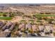 Sweeping aerial perspective of golf course-adjacent homes nestled in the desert, showcasing luxurious Scottsdale living at 19460 N 84Th St, Scottsdale, AZ 85255