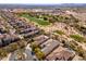 High-angle view of luxurious desert homes bordering a pristine Scottsdale golf course, blending recreation and comfort at 19460 N 84Th St, Scottsdale, AZ 85255