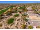 Elevated view of picturesque Scottsdale properties adjacent to a verdant golf course, offering a unique blend of leisure at 19460 N 84Th St, Scottsdale, AZ 85255