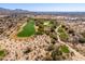 Scenic aerial depiction of Scottsdale residences adjoining a lush, green golf course, merging nature and luxury at 19460 N 84Th St, Scottsdale, AZ 85255