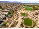 Picturesque aerial view showcasing golf course-adjacent homes with lush landscaping and desert terrain in Scottsdale at 19460 N 84Th St, Scottsdale, AZ 85255