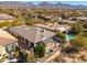 Aerial view of a beautifully landscaped backyard, a sparkling pool and inviting patio seating at 19460 N 84Th St, Scottsdale, AZ 85255