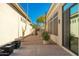 Charming courtyard featuring desert landscaping, a gravel ground cover, and potted succulents at 19460 N 84Th St, Scottsdale, AZ 85255