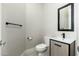 A powder bathroom features a modern vanity, square mirror and light fixtures at 19460 N 84Th St, Scottsdale, AZ 85255