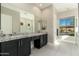 Bright bathroom featuring a double vanity, granite countertops, and natural light at 19460 N 84Th St, Scottsdale, AZ 85255