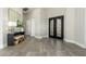 Spacious foyer with tile flooring, a decorative console table, and an elegant double door entry at 19460 N 84Th St, Scottsdale, AZ 85255