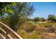 Secluded golf course view featuring an electric golf cart on the course at 19460 N 84Th St, Scottsdale, AZ 85255