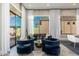 Cozy living room with stylish blue chairs, decorative pillows, and ample natural light at 19460 N 84Th St, Scottsdale, AZ 85255