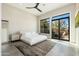 Sun-filled main bedroom with neutral tones, private patio, and a large window showcasing the outdoor scenery at 19460 N 84Th St, Scottsdale, AZ 85255