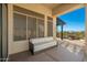 Comfortable covered patio features a white couch, offering an inviting outdoor living space at 19460 N 84Th St, Scottsdale, AZ 85255