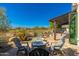 Outdoor patio area with a fire pit, comfortable seating, and desert landscaping at 19460 N 84Th St, Scottsdale, AZ 85255