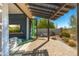 Covered outdoor patio with gas fire pit, comfortable seating, and seamless access to the indoor living area at 19460 N 84Th St, Scottsdale, AZ 85255