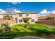 Landscaped backyard featuring a grassy area, trees, and a stucco fence at 20914 N 39Th Way, Phoenix, AZ 85050