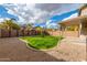 Landscaped backyard featuring a covered patio, decorative gravel, and a grassy area at 20914 N 39Th Way, Phoenix, AZ 85050