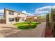 Well-maintained backyard featuring a grassy area surrounded by decorative gravel and trees at 20914 N 39Th Way, Phoenix, AZ 85050