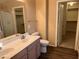 Well-lit bathroom featuring a double sink vanity and walk-in closet access at 20914 N 39Th Way, Phoenix, AZ 85050