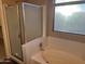 Bright bathroom with bathtub, shower, and large window at 20914 N 39Th Way, Phoenix, AZ 85050