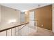 Upstairs hallway featuring carpet, a railing, and multiple doors at 20914 N 39Th Way, Phoenix, AZ 85050