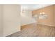 Spacious living room with wood-look tile flooring and elegant chandeliers at 20914 N 39Th Way, Phoenix, AZ 85050