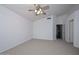 Spacious bedroom with neutral carpet, ceiling fan and walk in closet at 21511 N 79Th Dr, Peoria, AZ 85382