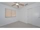 Standard bedroom featuring neutral carpet, a ceiling fan, a closet, and one window at 21511 N 79Th Dr, Peoria, AZ 85382