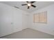 Standard bedroom featuring neutral carpet, a ceiling fan, a closet, and one window at 21511 N 79Th Dr, Peoria, AZ 85382